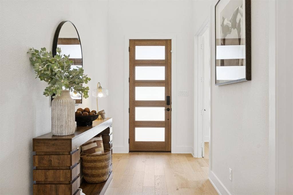 1117 Bradford Street, Celina, TX 75009 Entryway featuring a wood-finish door with frosted glass panels, light wood-finish flooring, and white walls
