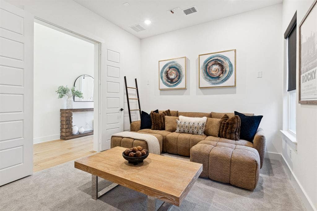 1117 Bradford Street, Celina, TX 75009 Carpeted interior space featuring recessed lighting, a wooden coffee table with a metal base, and white walls