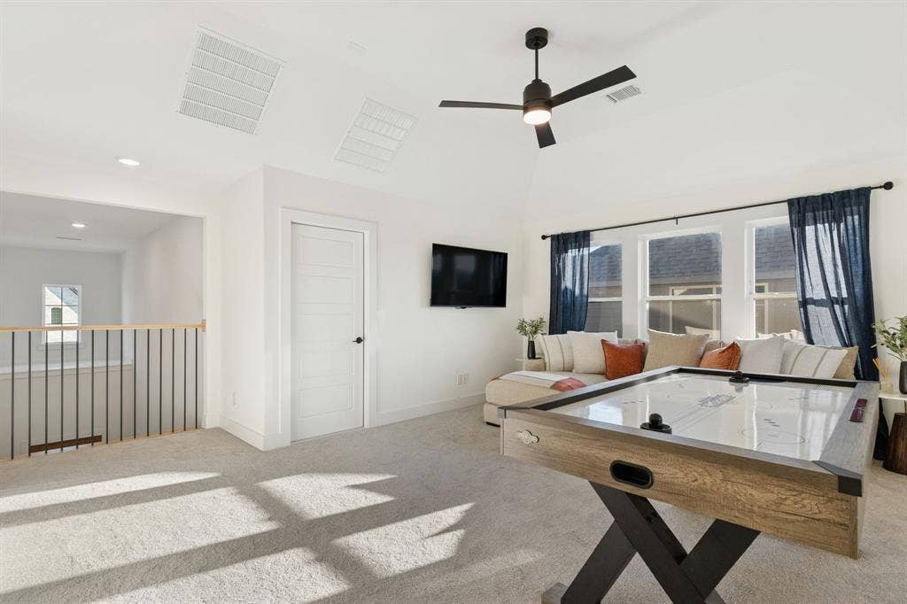 1117 Bradford Street, Celina, TX 75009 Spacious bonus room featuring vaulted ceilings, recessed lighting, and soft carpeting