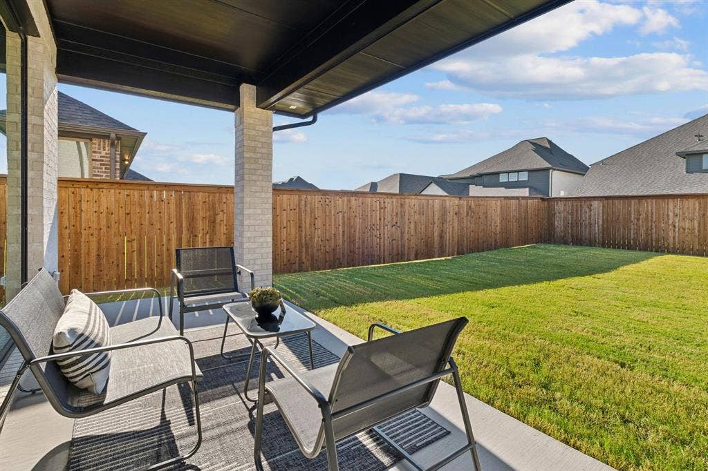 1117 Bradford Street, Celina, TX 75009 Covered concrete patio featuring brick columns, recessed lighting, and a dark soffit
