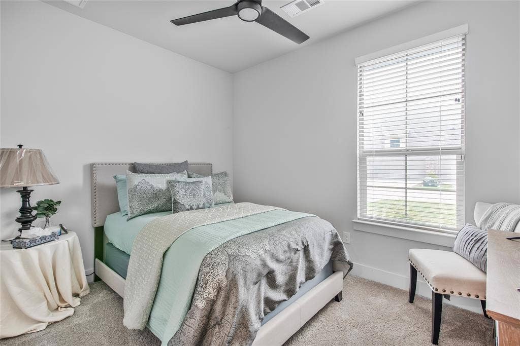 2644 Chardonnay Court, Grand Prairie, TX 75054 Plush carpeting, window with blinds, ceiling fan with integrated lighting, and a neutral color palette