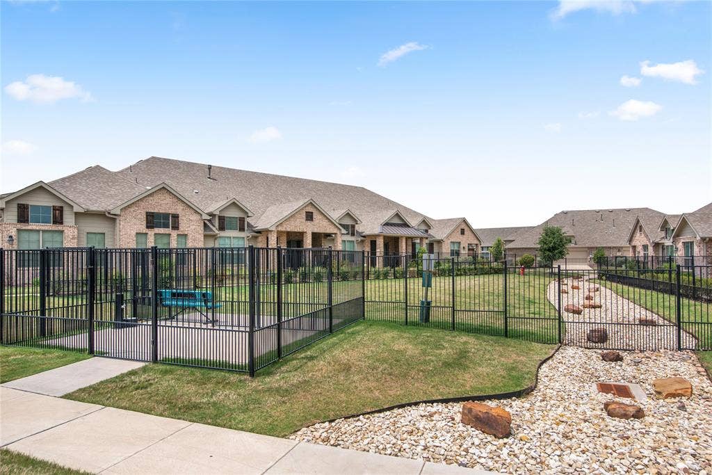 2644 Chardonnay Court, Grand Prairie, TX 75054 Fenced outdoor area with a gravel path, grass sections, and scattered large rocks