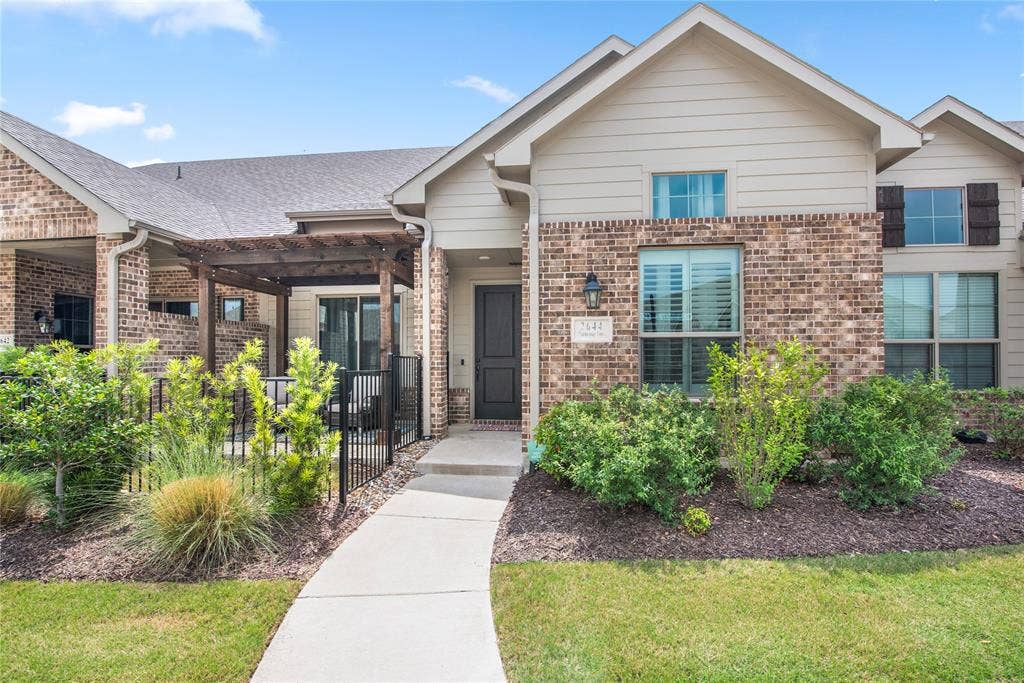 2644 Chardonnay Court, Grand Prairie, TX 75054 Brick and siding exterior with a concrete walkway, mature landscaping, and a wood-finish pergola