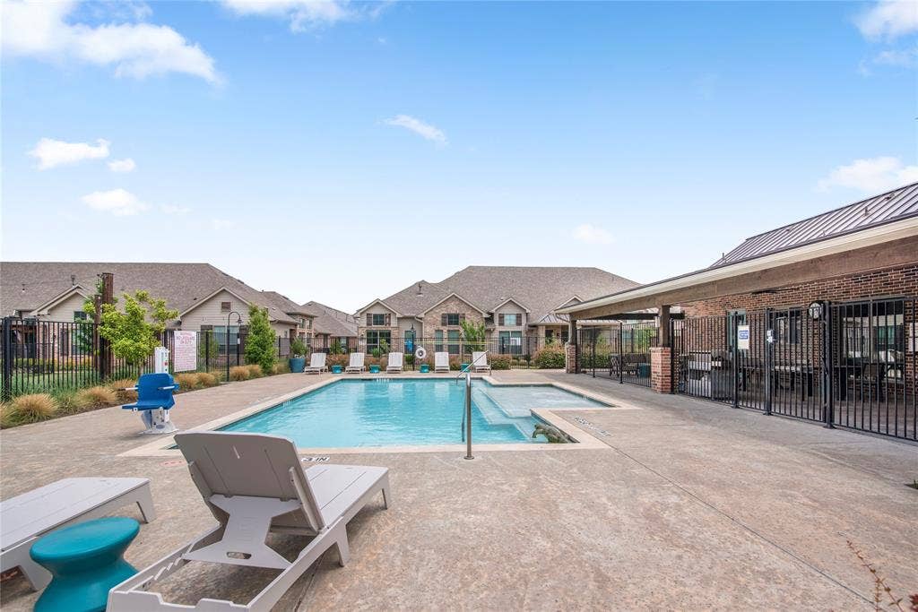 2644 Chardonnay Court, Grand Prairie, TX 75054 Community pool with an integrated spa, surrounded by a concrete patio and a covered outdoor area