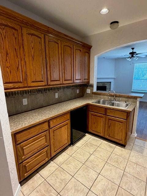 500 Leatherman Drive, Saginaw, TX 76179 Kitchen featuring wood cabinetry, a double basin stainless steel sink, tile flooring, and a stone-finish countertop