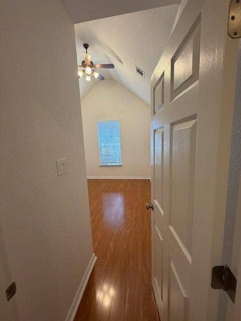500 Leatherman Drive, Saginaw, TX 76179 Vaulted ceiling room with wood-finish flooring, a ceiling fan with light, and natural light from a window with blinds