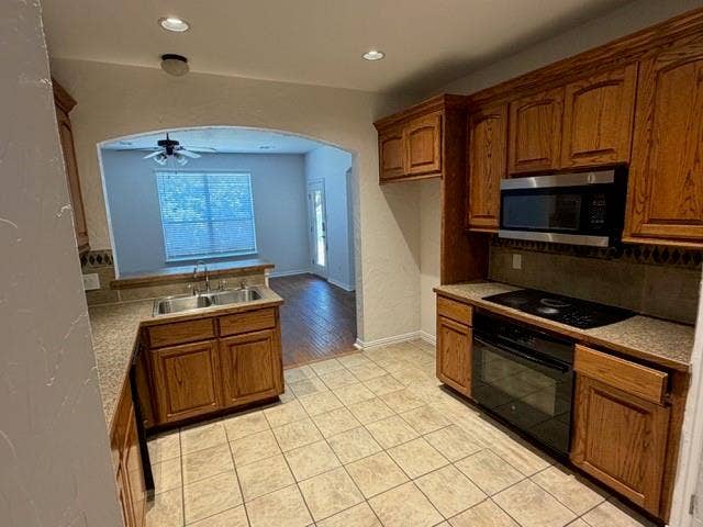 500 Leatherman Drive, Saginaw, TX 76179 Kitchen featuring tile flooring, wood cabinetry, stainless steel microwave, electric cooktop, and a double basin sink