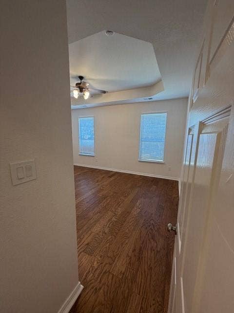 500 Leatherman Drive, Saginaw, TX 76179 Tray ceiling with a ceiling fan, two windows with blinds, and wood-finish flooring
