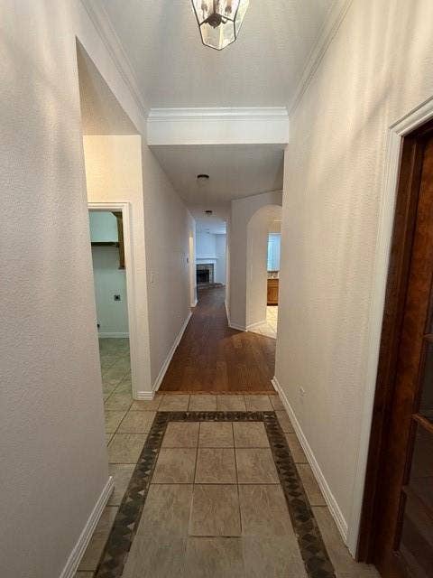 500 Leatherman Drive, Saginaw, TX 76179 Entryway featuring a decorative tile inlay, wood-finish flooring, and crown molding