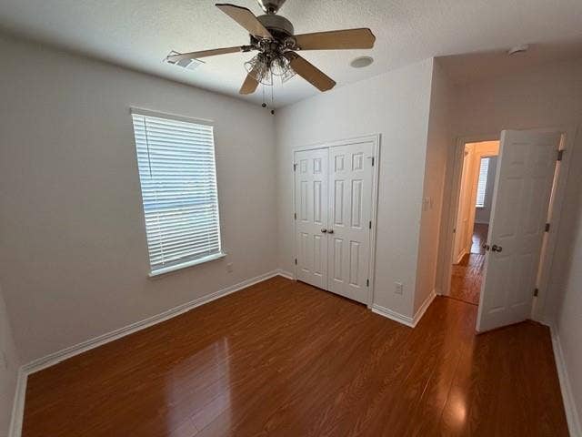 500 Leatherman Drive, Saginaw, TX 76179 Wood-finish flooring with crisp white baseboards, a double-door closet, and a ceiling fan with integrated lighting
