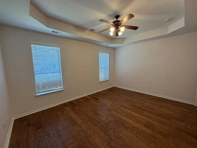 500 Leatherman Drive, Saginaw, TX 76179 Tray ceiling with a ceiling fan, two windows with blinds, and wood-finish flooring