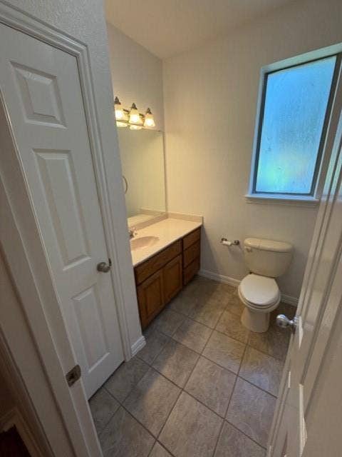 500 Leatherman Drive, Saginaw, TX 76179 Vanity with an integrated sink, wood-finish cabinetry, and a framed mirror