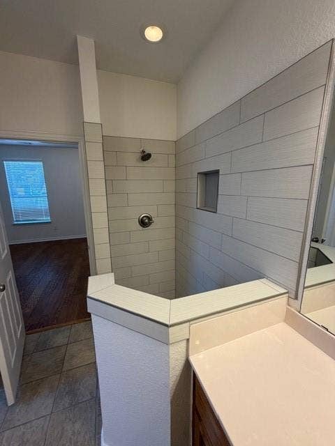 500 Leatherman Drive, Saginaw, TX 76179 Walk-in shower with subway tile surround, recessed niche, and dark bronze fixtures