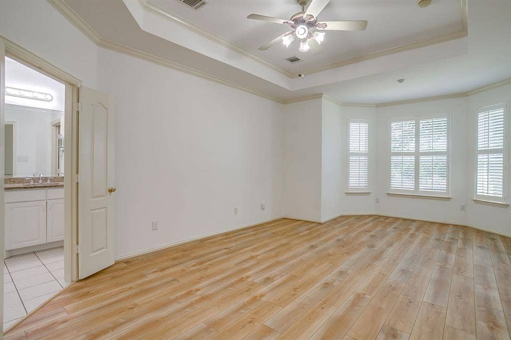 Primary bedroom with bay window overlooking the backyard.