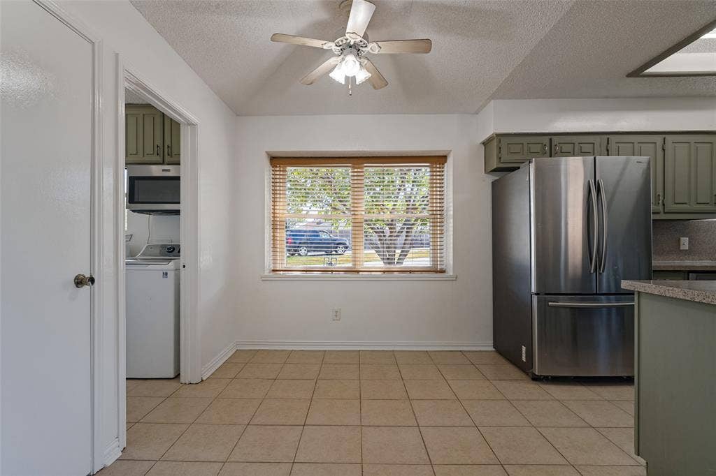 6527 Leasa Court, Sachse, TX 75048 Dining area with box window with wood-finish blinds.