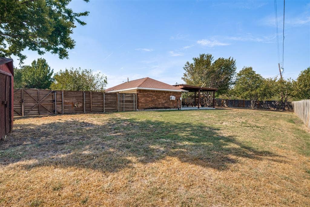 6527 Leasa Court, Sachse, TX 75048 Expansive backyard with a wood privacy fence.