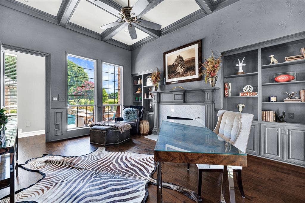 5325 BLAKE Drive, Plano, TX 75093 Floor-to-ceiling windows flood the study with natural light while offering direct views of the backyard pool patio. Custom built-in cabinetry provides ample storage, combining high functionality with refined executive style.