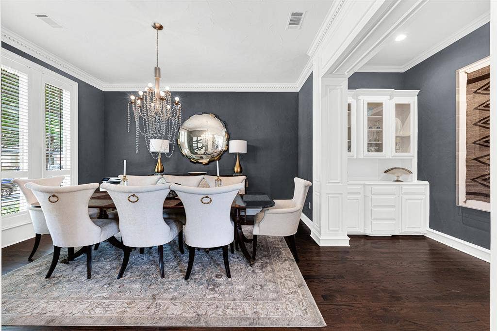 5325 BLAKE Drive, Plano, TX 75093 Dramatic charcoal walls and a glittering crystal chandelier elevate this formal dining space, complete with a built-in white buffet and server station. Host memorable holiday dinners and celebratory family meals in a space designed for effortless hospitality.