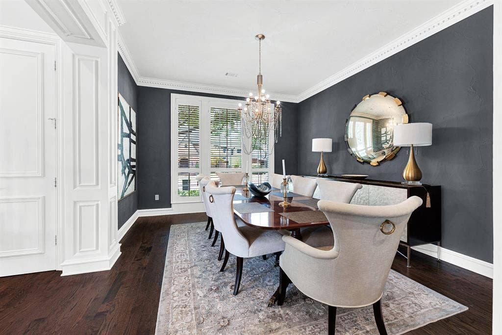 5325 BLAKE Drive, Plano, TX 75093 Large windows fitted with classic plantation shutters fill the dining room with soft, ambient light across rich wood flooring. It’s a stylish setting for dinner parties, where guests can gather comfortably around a large table surrounded by timeless architectural trim.