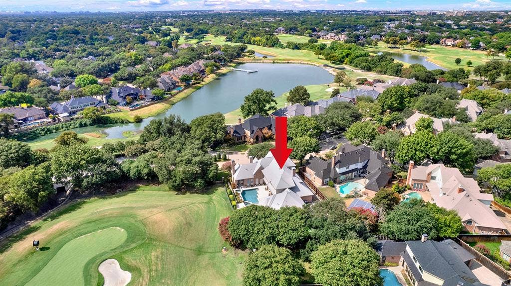 5325 BLAKE Drive, Plano, TX 75093 High-altitude aerial photography highlights the estate's prime positioning along the golf course green and nearby lake. Surrounded by mature tree lines and luxury properties, the home sits on an exceptionally private lot