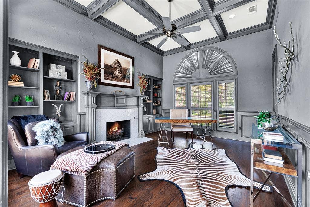 5325 BLAKE Drive, Plano, TX 75093 Moulded coffered ceilings, charcoal walls, and built-in shelving surround a central gas fireplace in this handsome private study that could be a fifth bedroom. It is an ideal setting for working from home or relaxing with a book by the fire.
