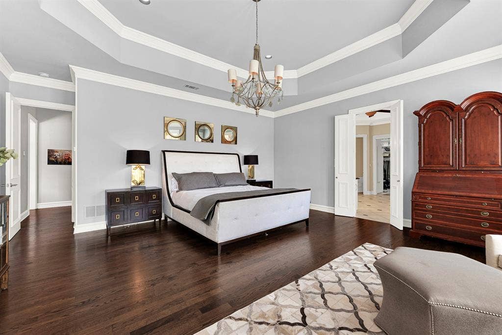 5325 BLAKE Drive, Plano, TX 75093 Generous square footage comfortably allows for a king-size bed setup alongside large accent dressers and custom armoires. Soft blue-gray walls, crisp white trim, and double doors opening into the ensuite bath complete this peaceful sanctuary.