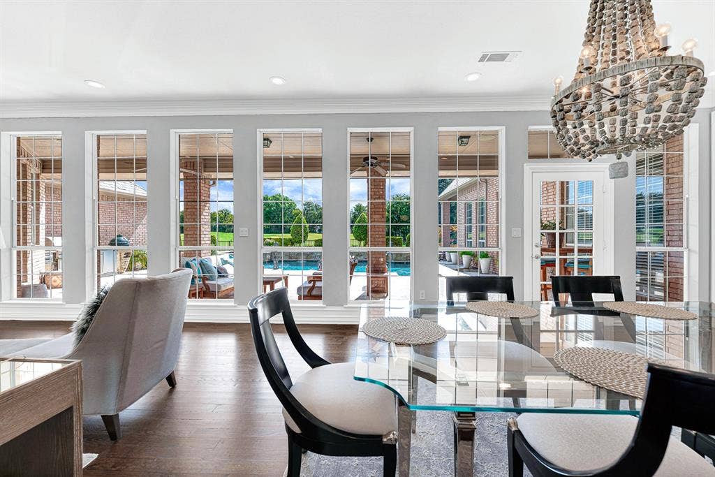 5325 BLAKE Drive, Plano, TX 75093 A wall of floor-to-ceiling windows frames uninterrupted views of the resort-style pool patio and green fairway beyond. This casual dining nook bathes morning meals in natural light while offering quick access through French doors to the outdoor covered patio, pool and coveted golf course views.