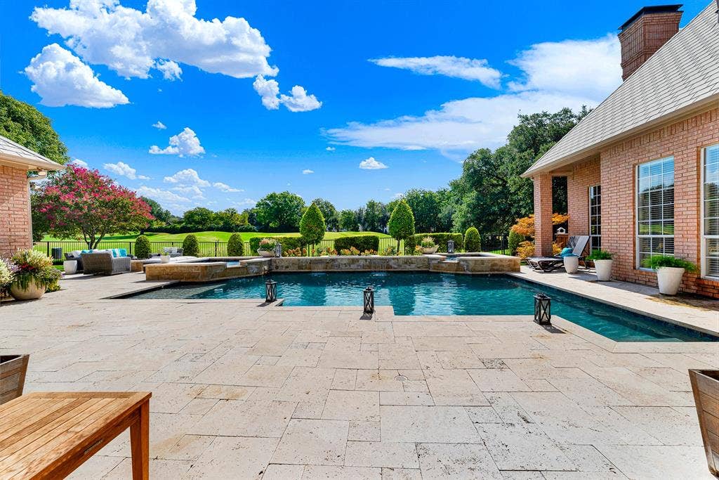 5325 BLAKE Drive, Plano, TX 75093 Paved travertine coping framing the resort-style pool opens directly to serene, green views of the surrounding course. Sip your morning coffee in total peace as you soak in uninterrupted golf course panoramas