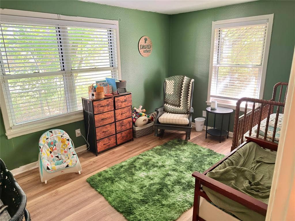 3014 Crestview Street, Tyler, TX 75701 Wood-finish flooring with a green wall finish