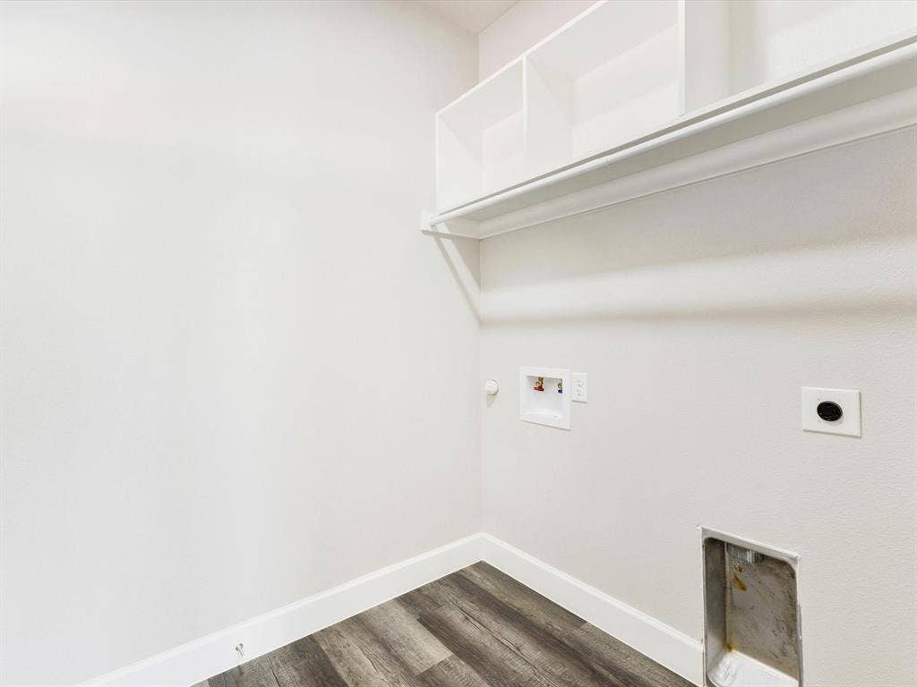 292 Harris Boulevard, Malakoff, TX 75148 Utility area featuring built-in shelving, a clothes rod, wood-finish flooring, and white baseboards