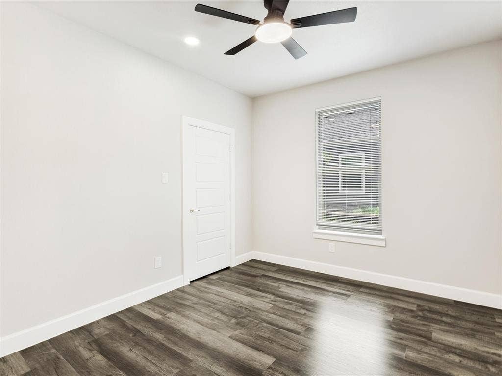 292 Harris Boulevard, Malakoff, TX 75148 Wood-finish flooring with white baseboards and neutral wall paint