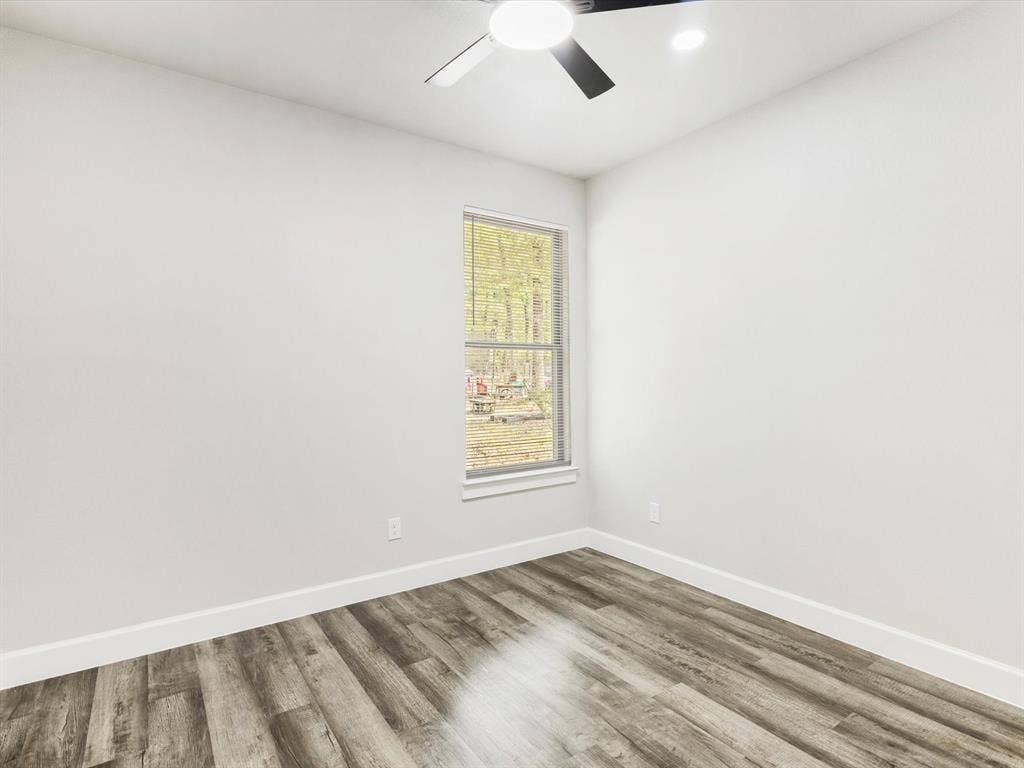 292 Harris Boulevard, Malakoff, TX 75148 Wood-finish flooring, white walls, and a ceiling fan with integrated lighting