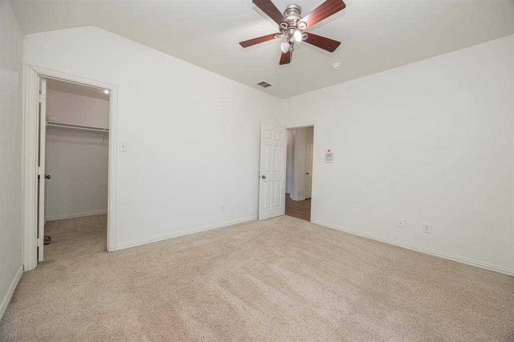 6405 Sapphire Drive, McKinney, TX 75070 Neutral-toned carpet flooring, light-colored walls, ceiling fan with integrated lighting, and a closet with built-in shelving