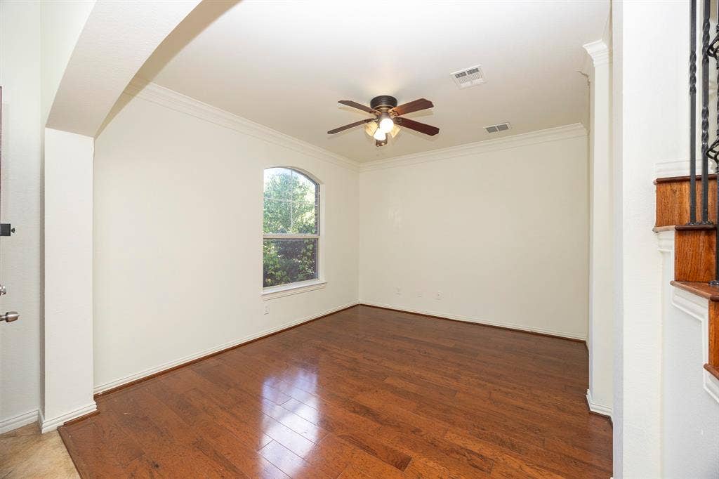 6405 Sapphire Drive, McKinney, TX 75070 Hardwood flooring, arched entryway, crown molding, arched window, and ceiling fan with integrated lighting