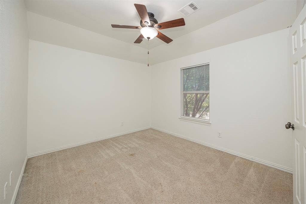 6405 Sapphire Drive, McKinney, TX 75070 Recessed window, ceiling fan with integrated lighting, neutral carpet, and white paneled door
