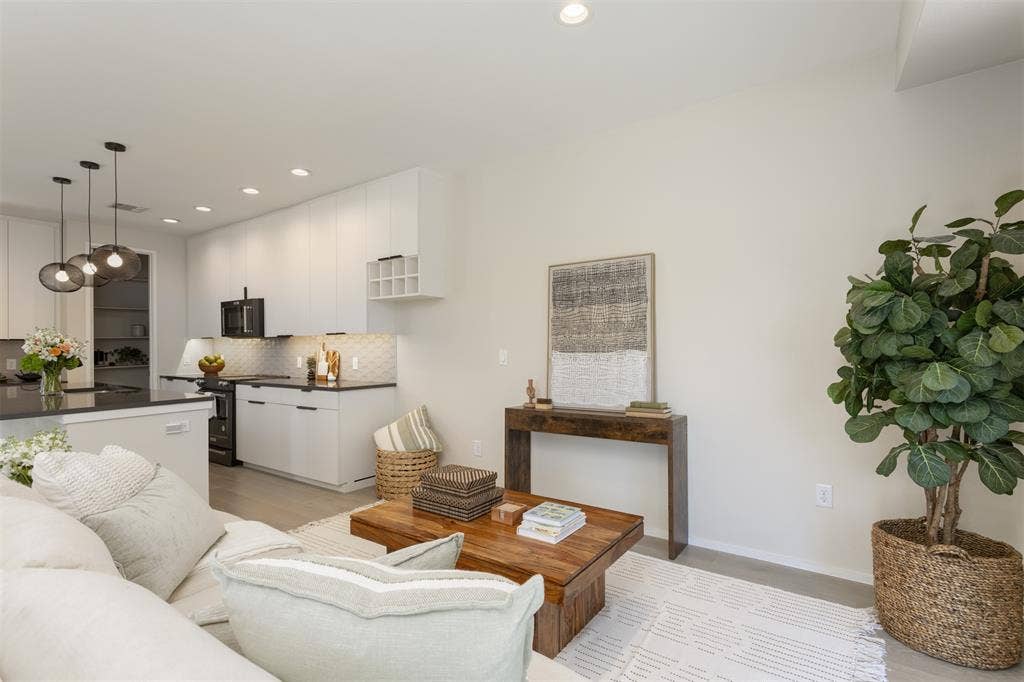 Living area featuring baseboards and recessed lighting
