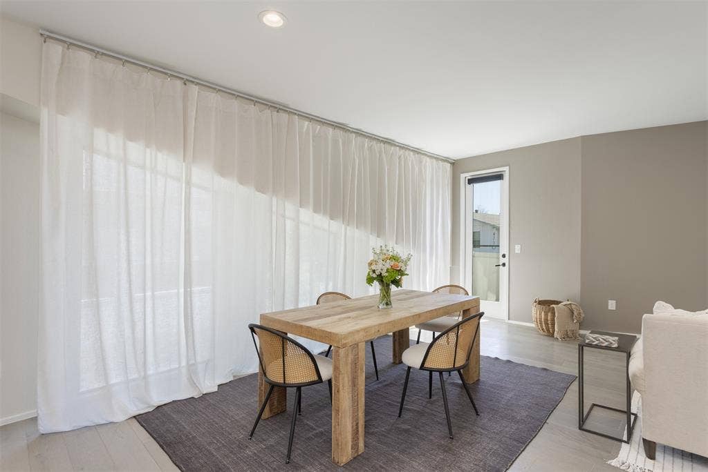 Dining area with light wood-style flooring and recessed lighting