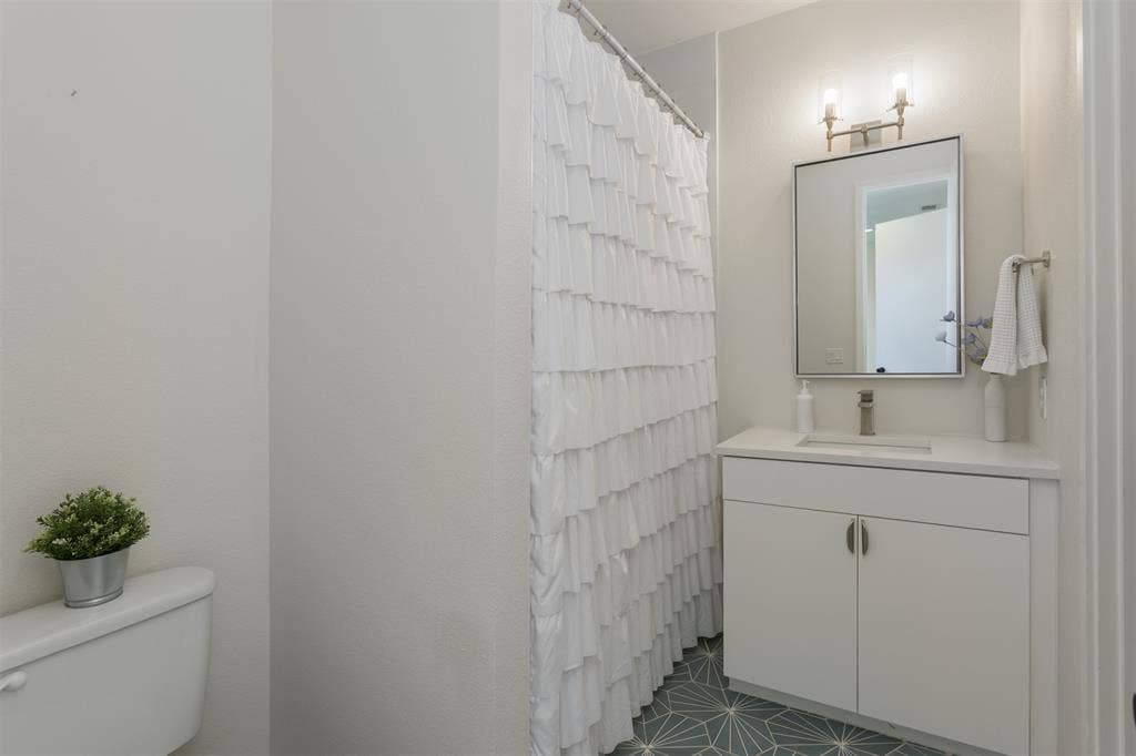 Full bath with vanity and curtained shower