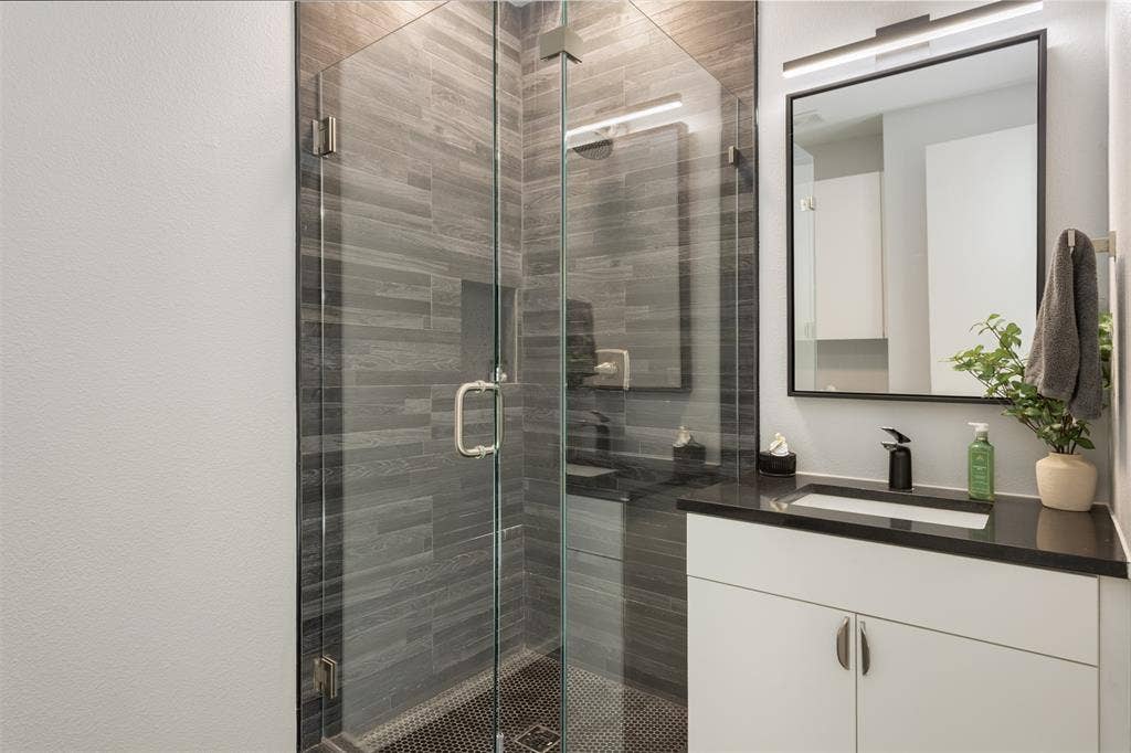 Full bathroom with vanity and a stall shower