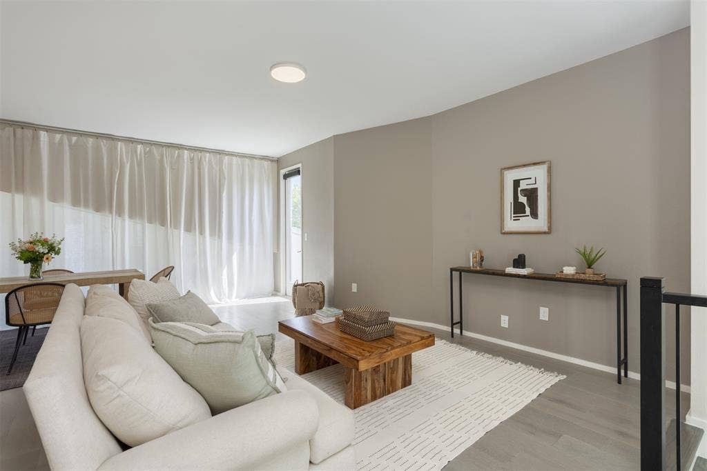 Living room with light wood finished floors and baseboards