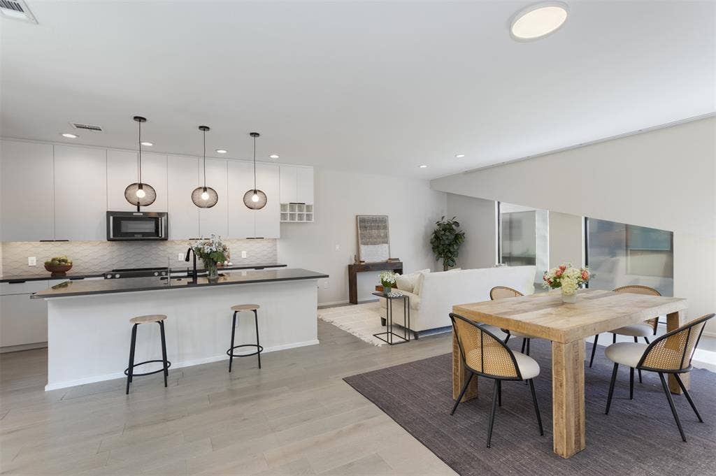 Dining/Living area featuring light wood-type flooring and recessed lighting