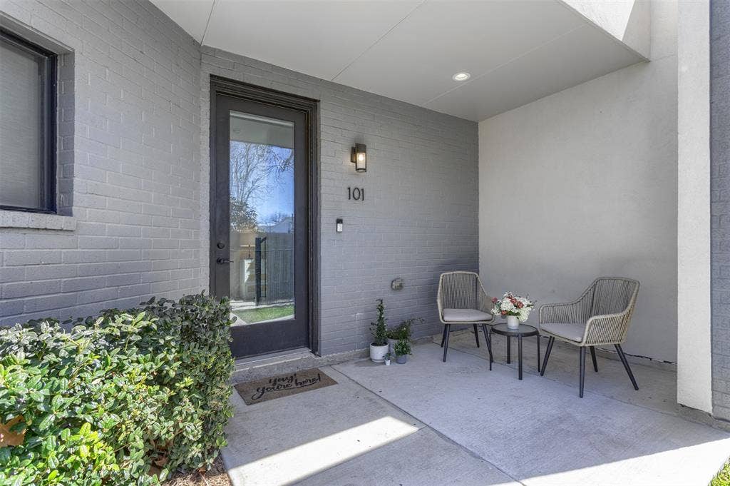 View of exterior entry featuring brick siding