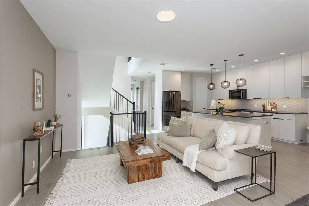 Living room featuring stairway and light wood-style floors