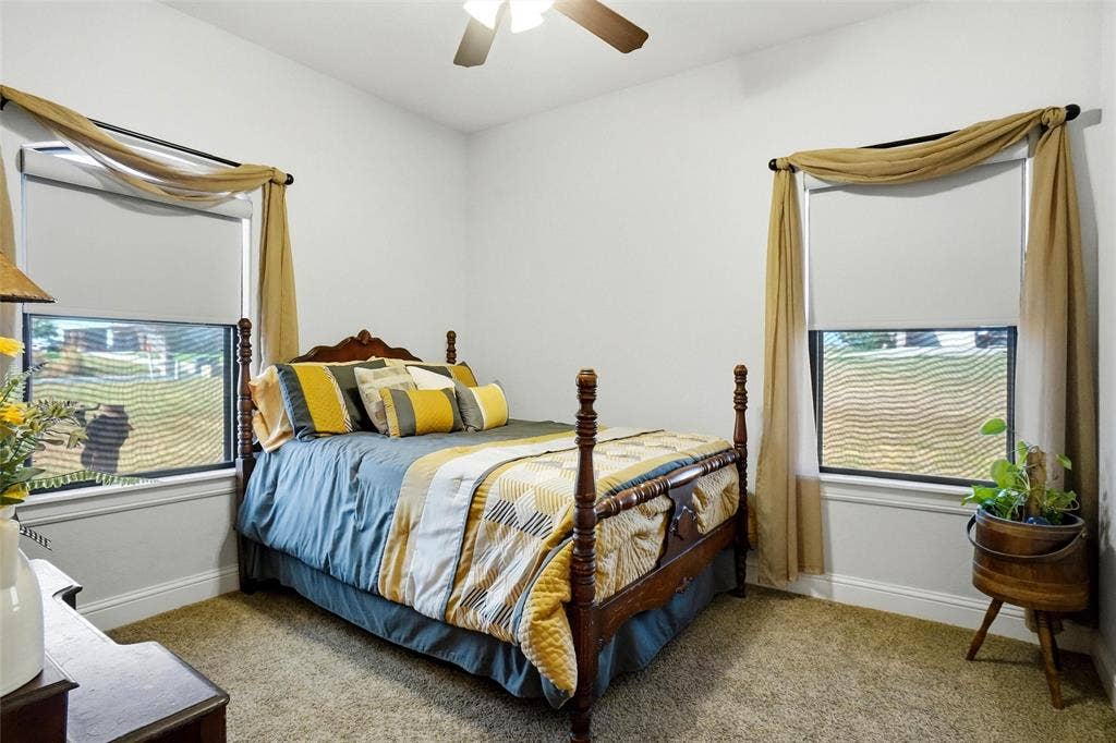 Secondary bedroom has ceiling fan and walk-in closet.