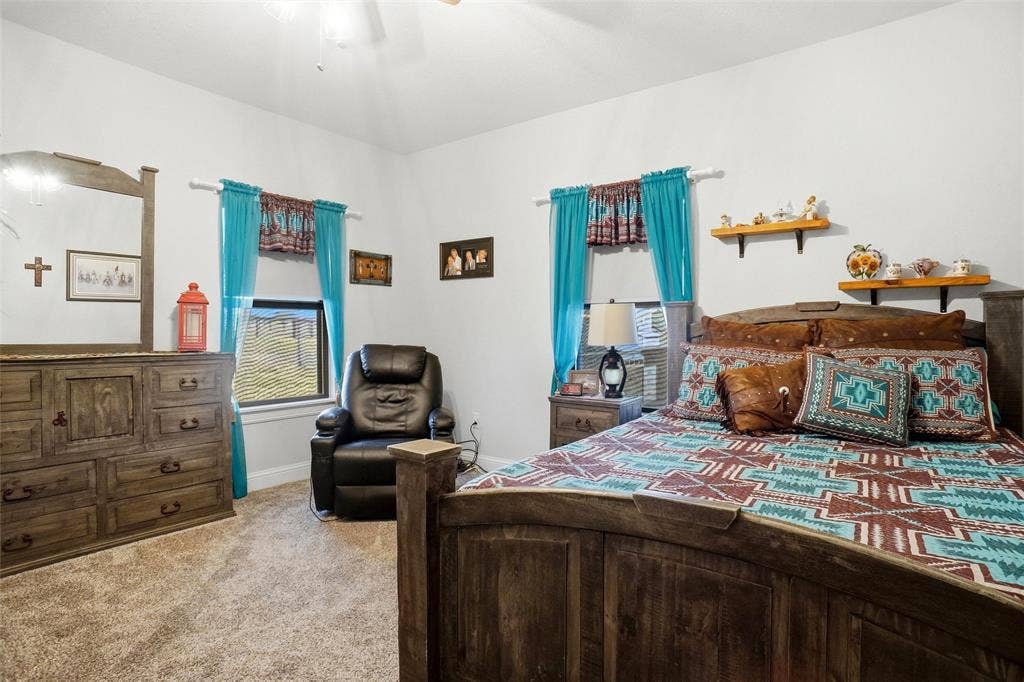 Secondary bedroom with ceiling fan and walk-in closet.