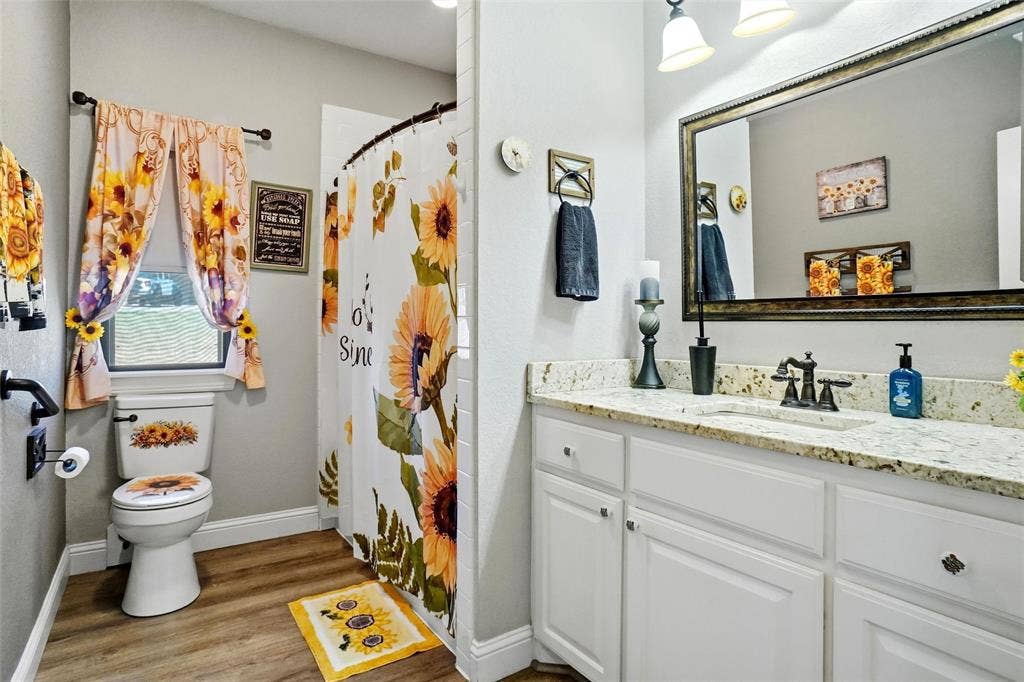 Guest bathroom with walk in shower and leathered granite countertops.