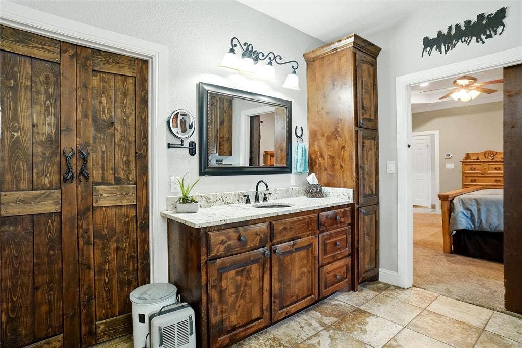 His and hers vanities with coppper sinks.
