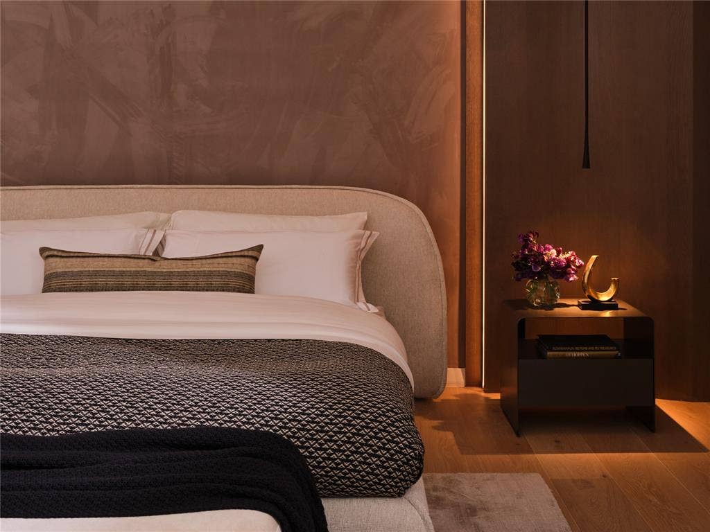 3310 Fairmount Street, #P3B, Dallas, TX 75201 Primary Bedroom highlights include Phillip Jeffries® velvet accent wall and curved rift-cut white oak paneling and pendant lighting.