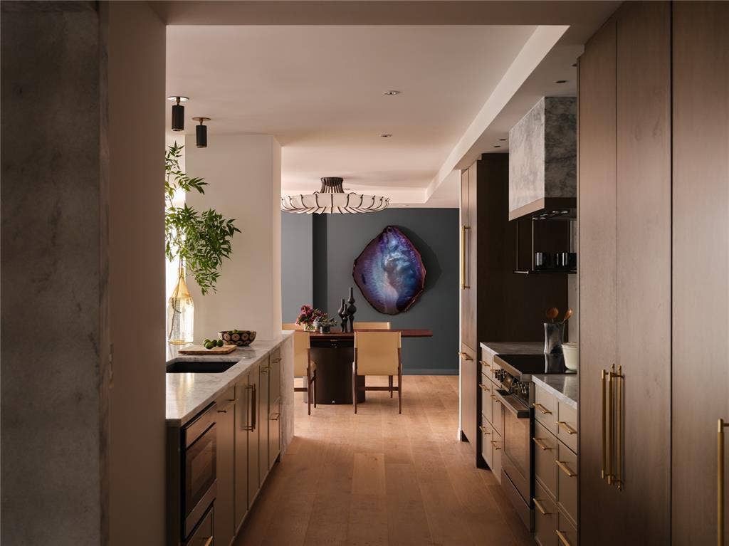3310 Fairmount Street, #P3B, Dallas, TX 75201 Kitchen leads to dining room with feature wall and Arteriors lighting.