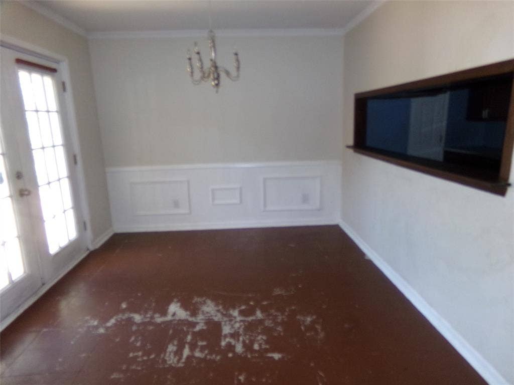 211 S Alexander Avenue, Duncanville, TX 75116 White wainscoting and crown molding accent the walls